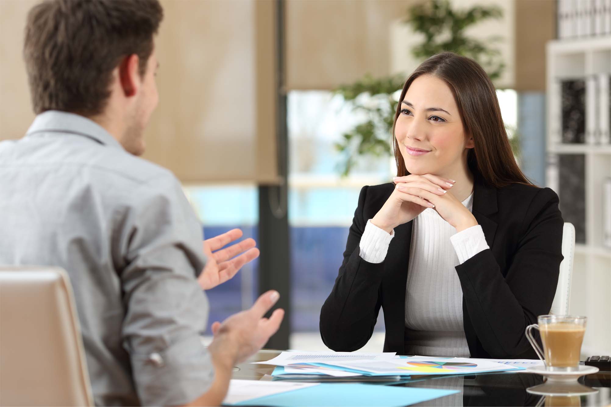 Businesswoman attending listening to a client who is talking at office